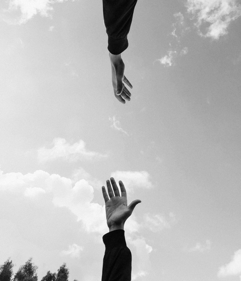two hands reaching for each other 