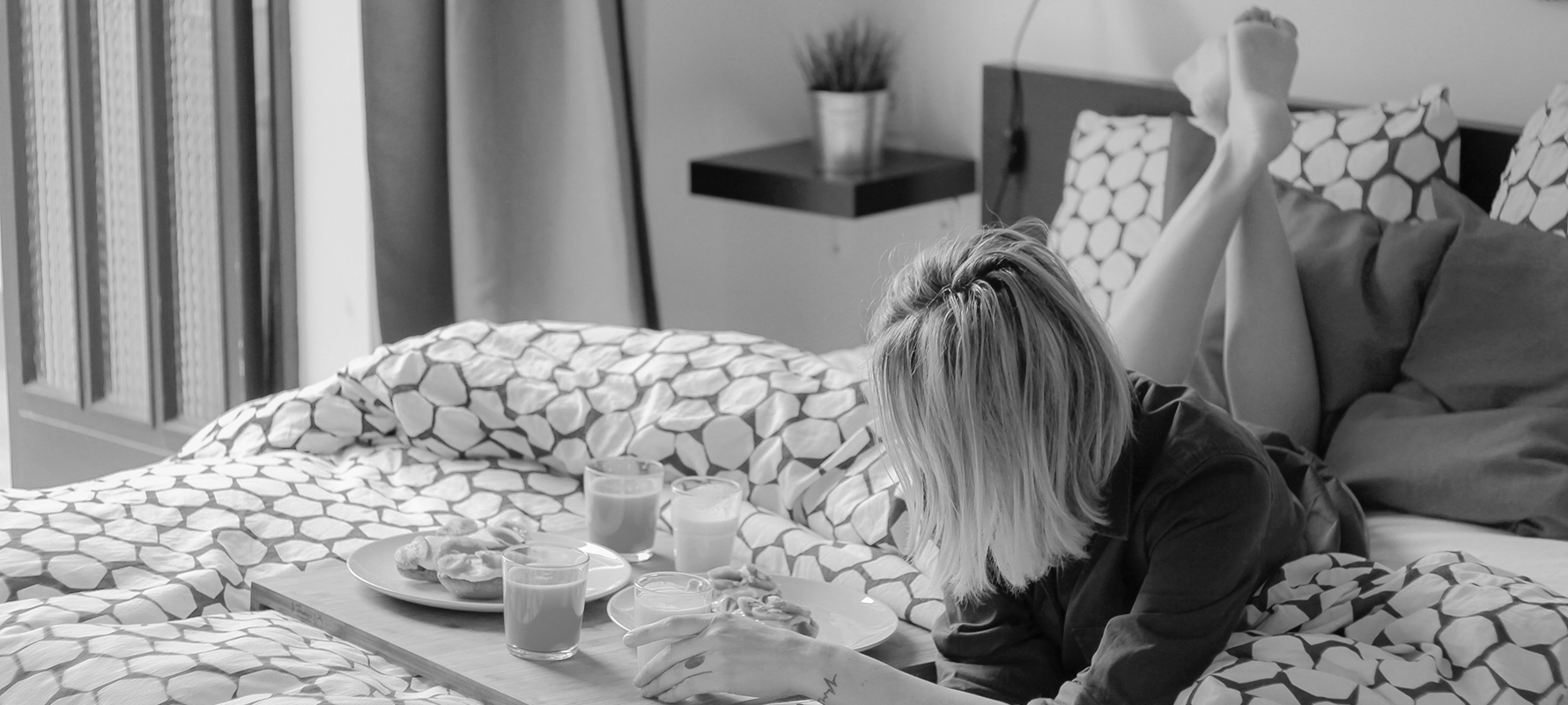 A woman eating breakfast in bed.
